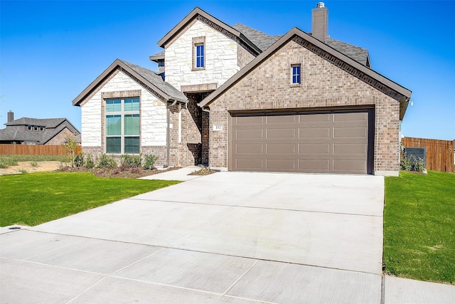 view of front of home featuring a garage and a front lawn