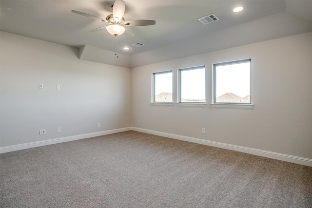 empty room with ceiling fan and carpet floors