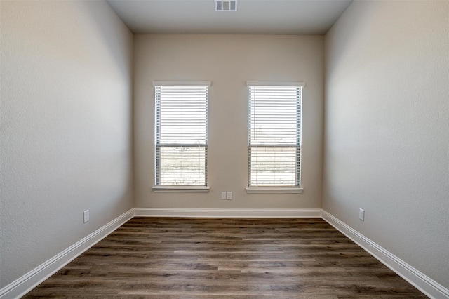 unfurnished room featuring dark wood-type flooring