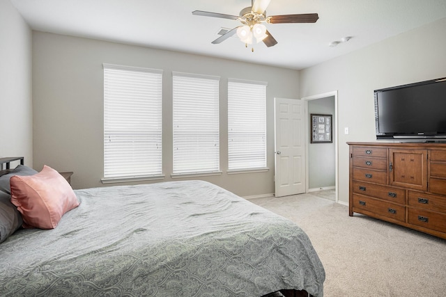 carpeted bedroom with multiple windows and ceiling fan