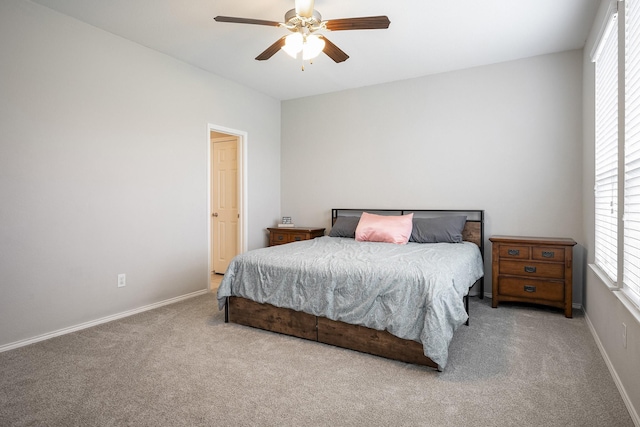 bedroom with ceiling fan and light carpet