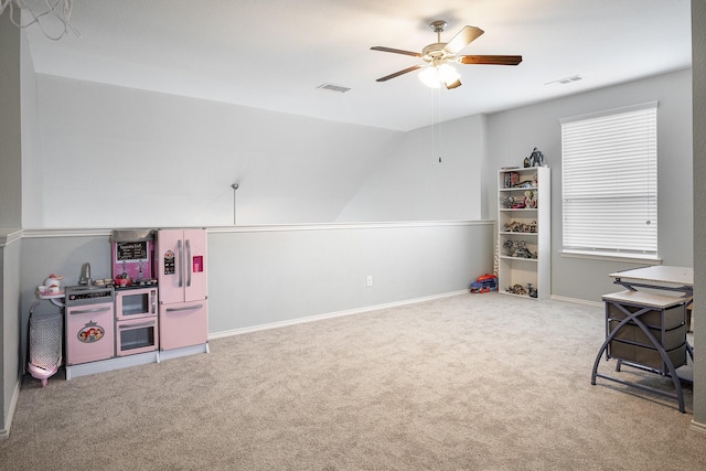 playroom with a wealth of natural light, carpet floors, ceiling fan, and lofted ceiling