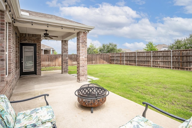 view of patio with ceiling fan and an outdoor fire pit