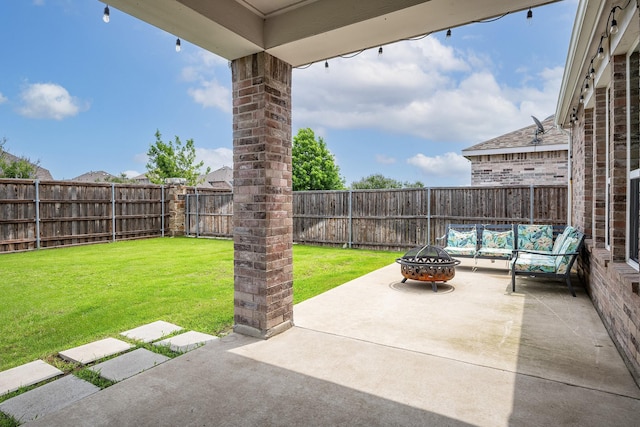 view of patio with an outdoor living space with a fire pit