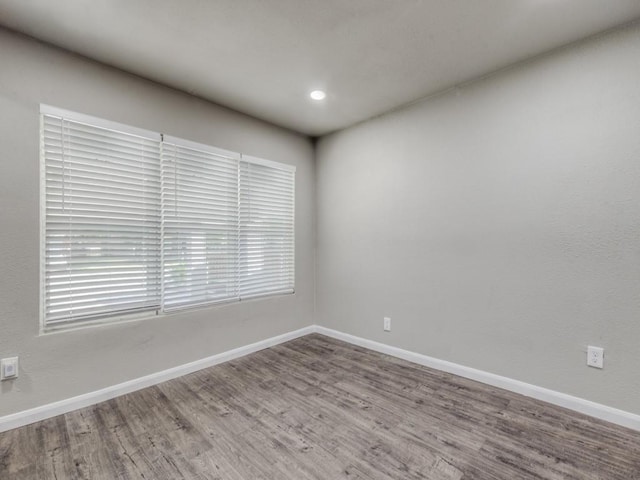 unfurnished room with wood-type flooring