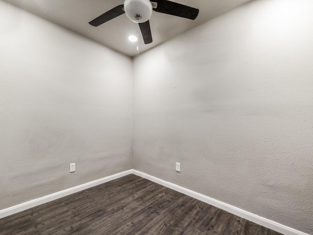 unfurnished room featuring ceiling fan and dark hardwood / wood-style flooring