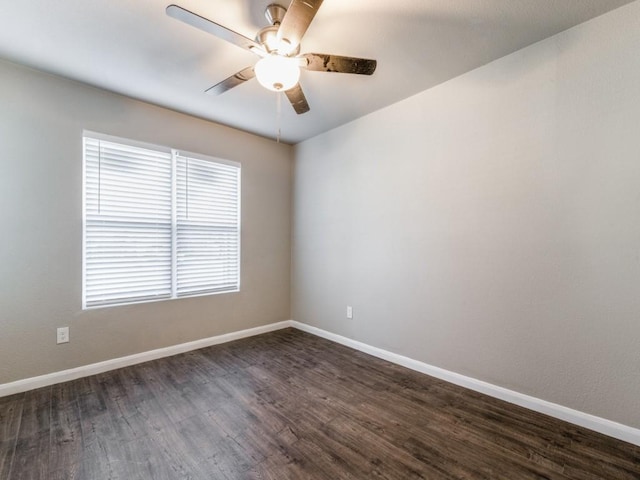 unfurnished room with ceiling fan and dark wood-type flooring