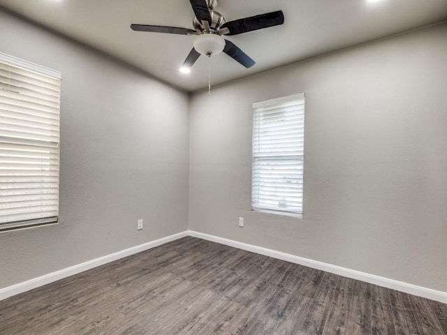 spare room with ceiling fan and dark hardwood / wood-style flooring