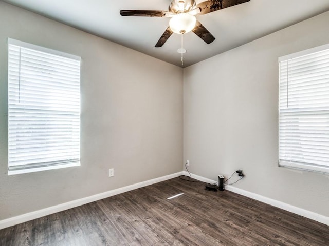 empty room with ceiling fan and dark hardwood / wood-style flooring