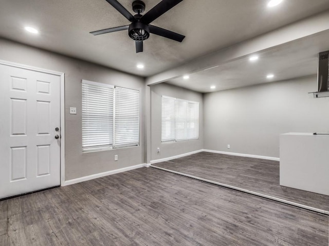 entryway with ceiling fan and dark wood-type flooring