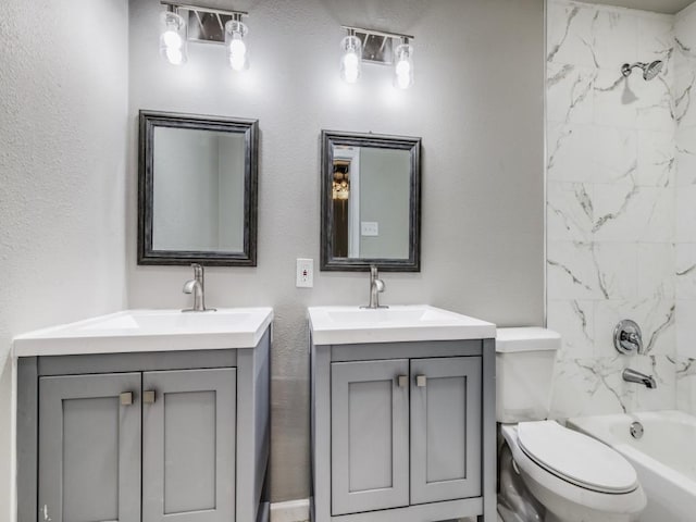 full bathroom featuring vanity, toilet, and tiled shower / bath