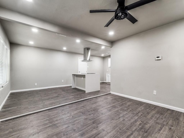 unfurnished living room featuring dark hardwood / wood-style floors, ceiling fan, and a wealth of natural light