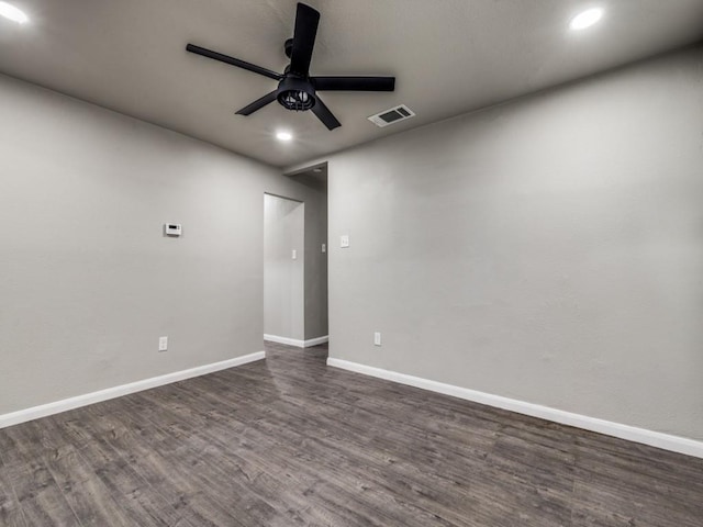 spare room with ceiling fan and dark hardwood / wood-style flooring