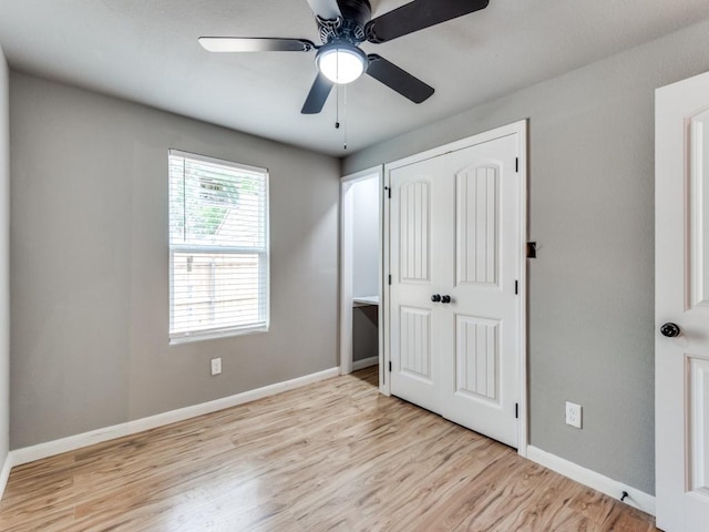 unfurnished bedroom featuring ceiling fan, light hardwood / wood-style flooring, and a closet