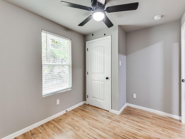 unfurnished bedroom with ceiling fan and light hardwood / wood-style floors