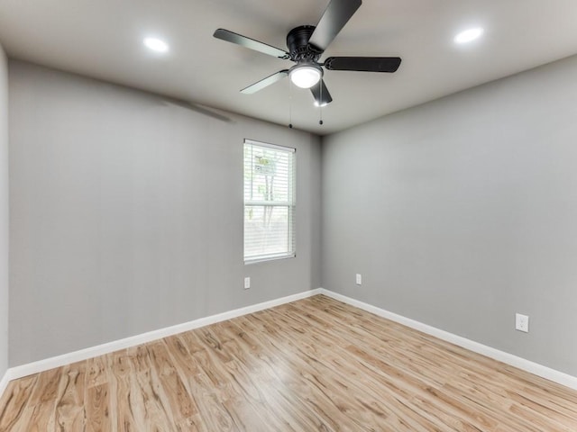 spare room with ceiling fan and light wood-type flooring