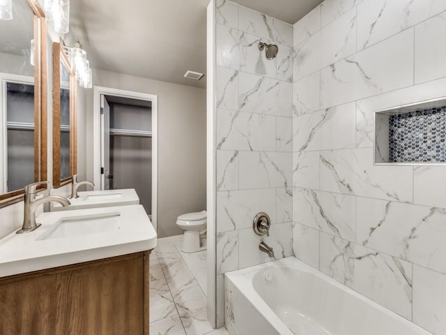 full bathroom featuring vanity, toilet, and tiled shower / bath