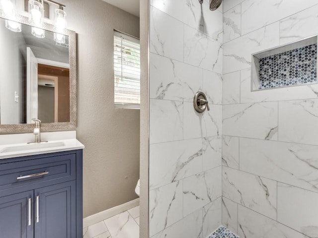 bathroom with vanity and a tile shower