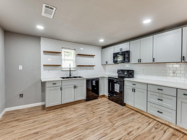 kitchen with sink, backsplash, and black appliances