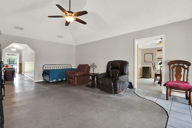 interior space featuring vaulted ceiling, concrete flooring, and ceiling fan