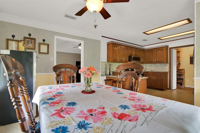 dining room with ceiling fan and ornamental molding