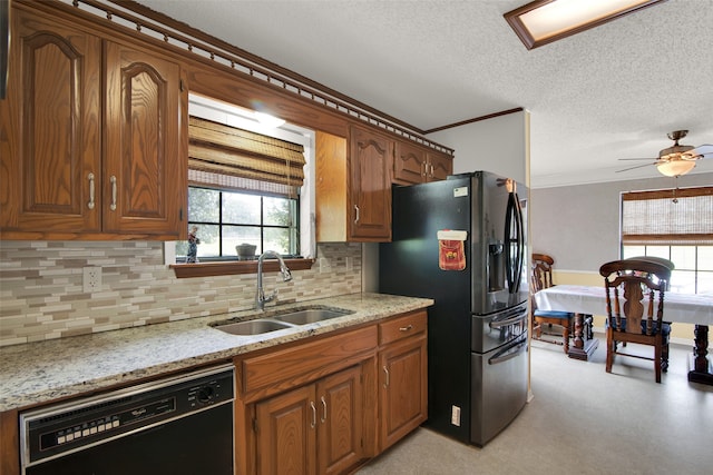 kitchen featuring a wealth of natural light, black dishwasher, sink, and stainless steel fridge with ice dispenser