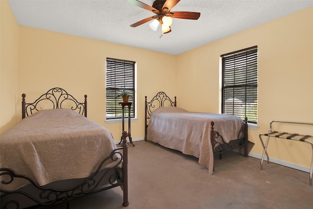 carpeted bedroom with multiple windows, ceiling fan, and a textured ceiling