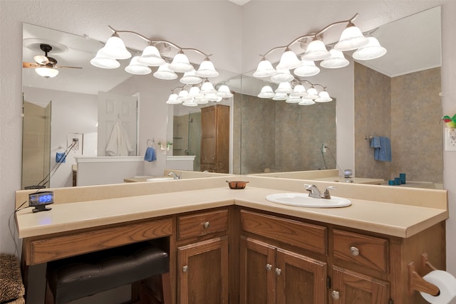 bathroom with a shower with door, vanity, and ceiling fan