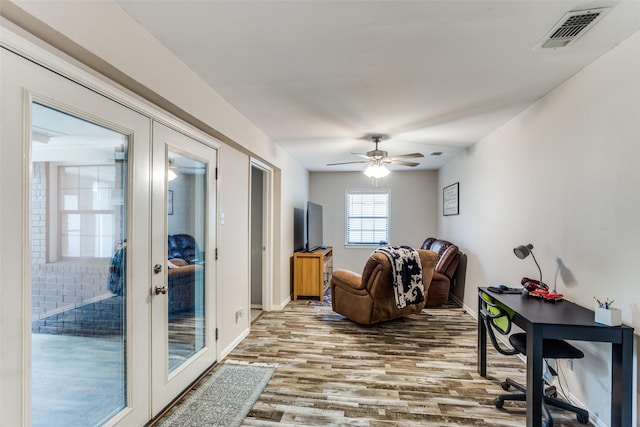 living room with ceiling fan, french doors, and wood-type flooring