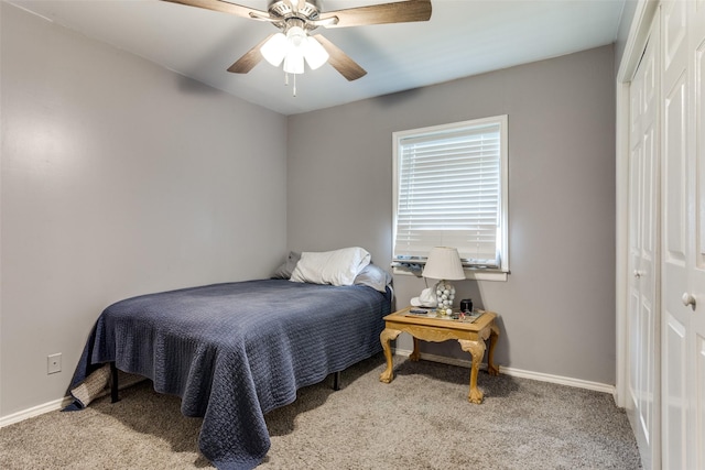 carpeted bedroom featuring a closet and ceiling fan