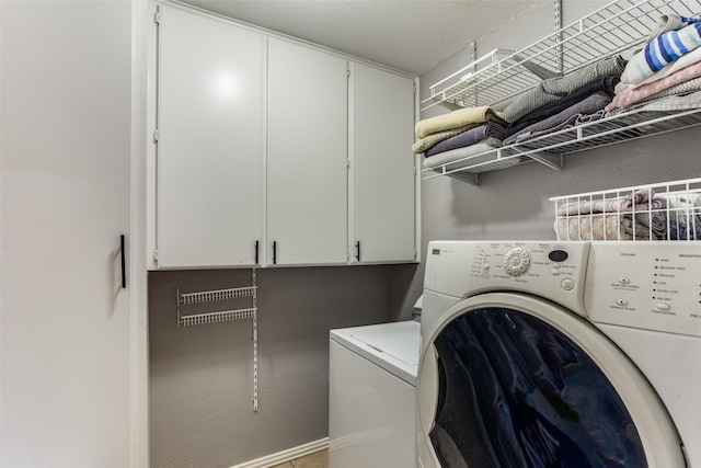 laundry area with cabinets and washer and dryer