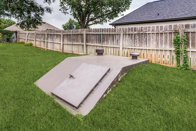 view of storm shelter with a yard