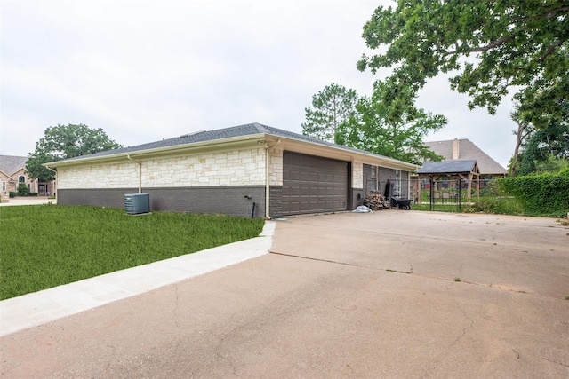 view of side of property with a lawn and a garage