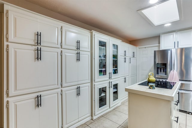 kitchen featuring white cabinetry and a skylight