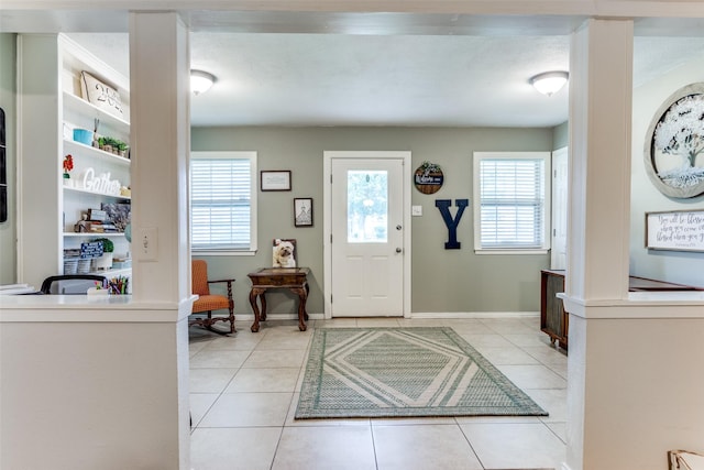 foyer entrance with light tile patterned flooring