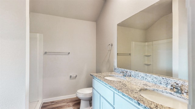 bathroom with lofted ceiling, vanity, walk in shower, wood-type flooring, and toilet