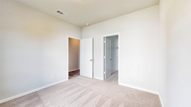 unfurnished bedroom featuring light carpet