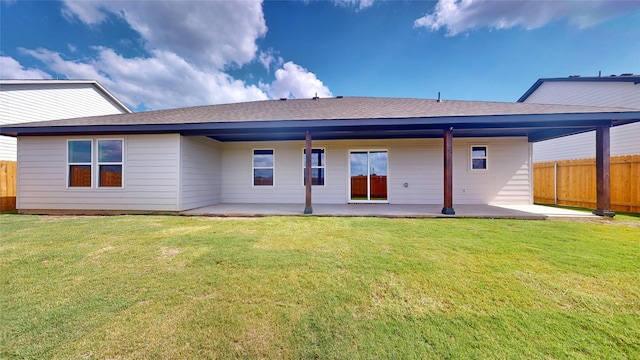 rear view of house featuring a lawn and a patio area