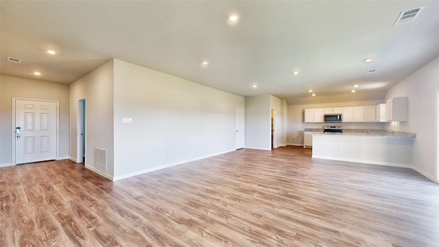 unfurnished living room with light hardwood / wood-style floors