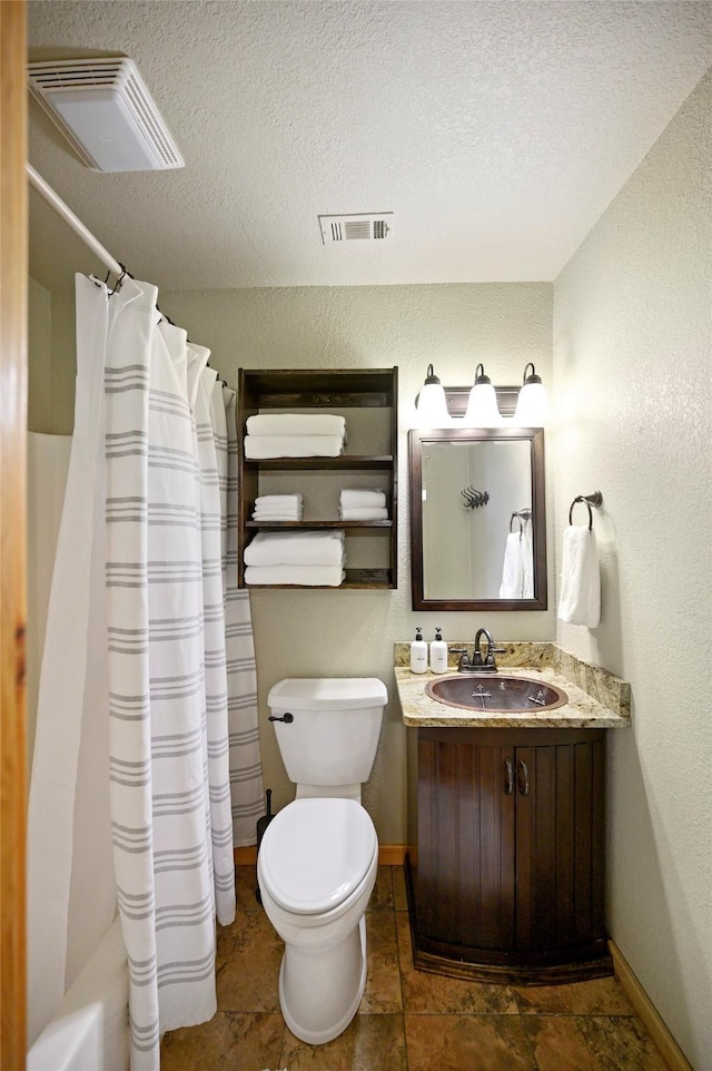 full bathroom featuring shower / bath combo, vanity, a textured ceiling, and toilet