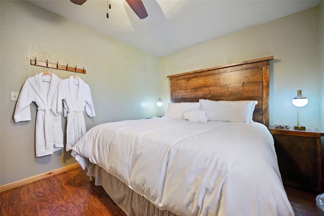 bedroom with dark hardwood / wood-style floors and ceiling fan