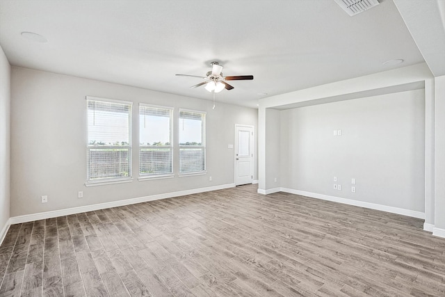 spare room featuring wood-type flooring and ceiling fan