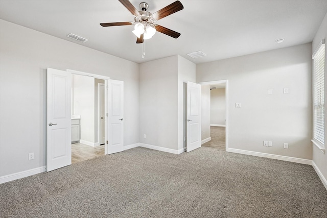 unfurnished bedroom with ceiling fan and light colored carpet