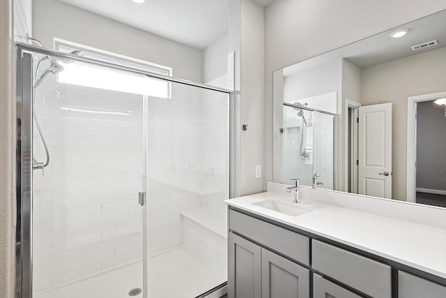 bathroom featuring vanity and a shower with door