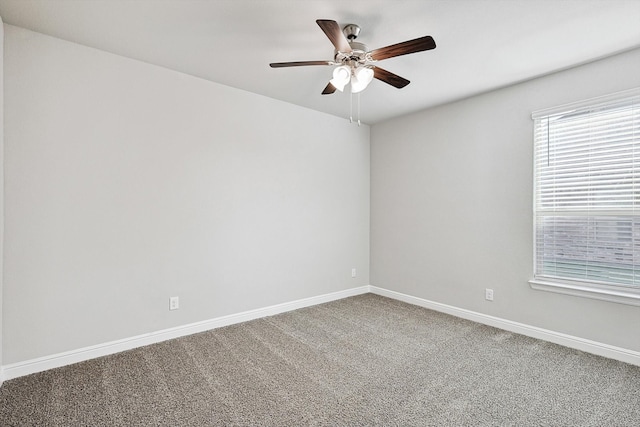 spare room featuring carpet and ceiling fan