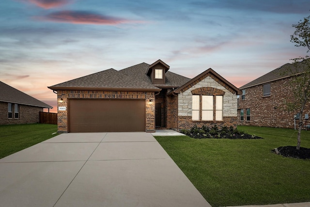 view of front of home with a lawn and a garage