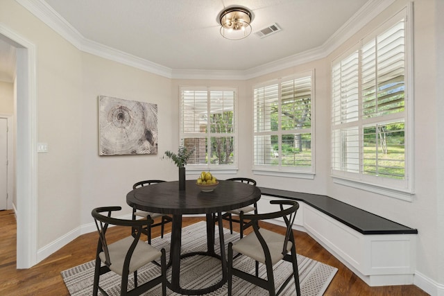 dining room featuring crown molding and dark wood-type flooring