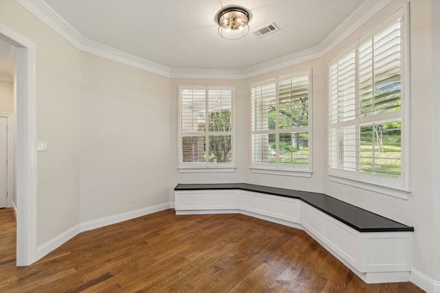 empty room featuring crown molding and dark wood-type flooring