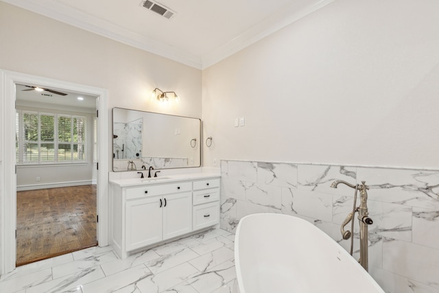 bathroom featuring a bathtub, ornamental molding, ceiling fan, wood-type flooring, and tile walls