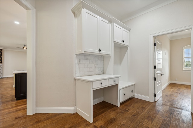 interior space with dark hardwood / wood-style floors, ceiling fan, and ornamental molding